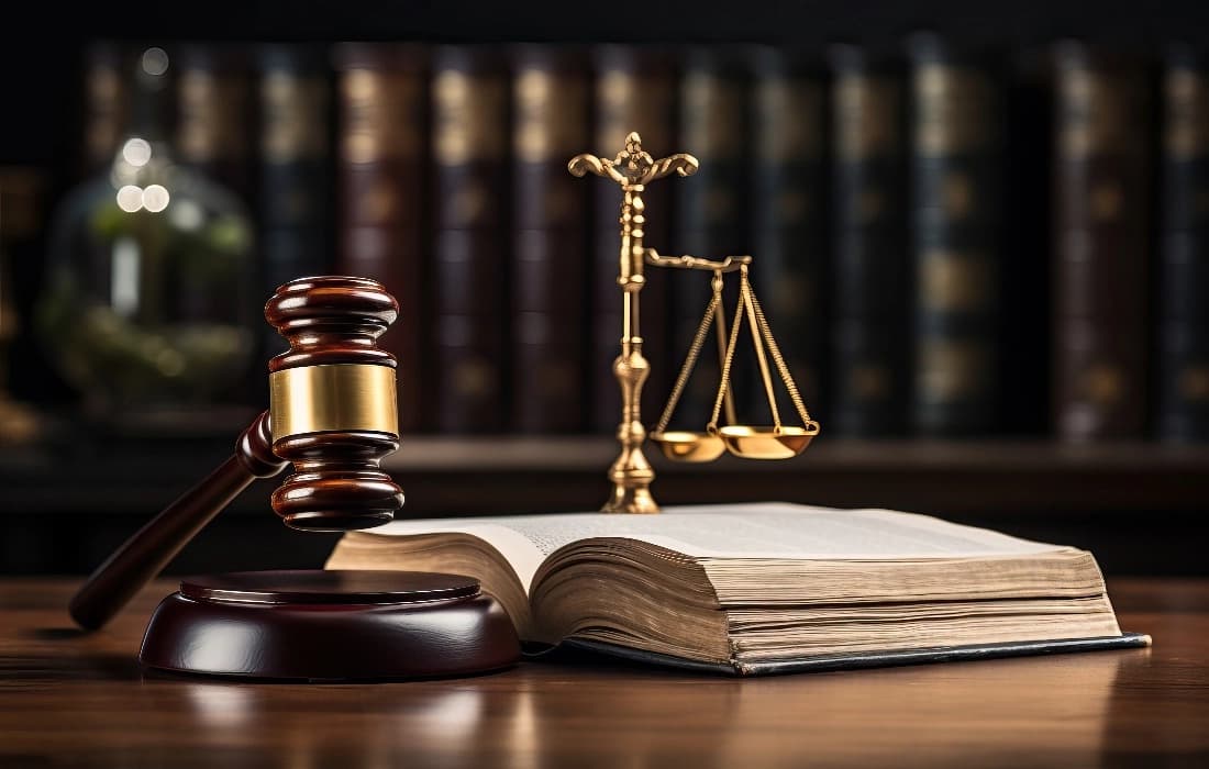 Legal books, a judge gavel and scales of justice