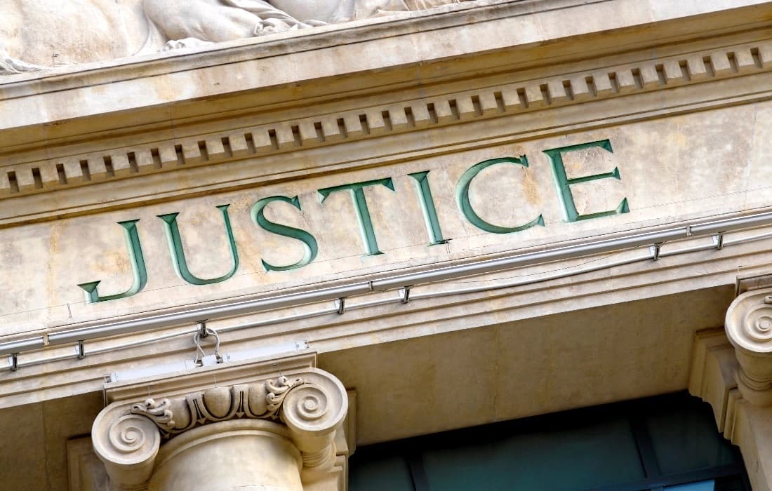 Court building facade with the word Justice